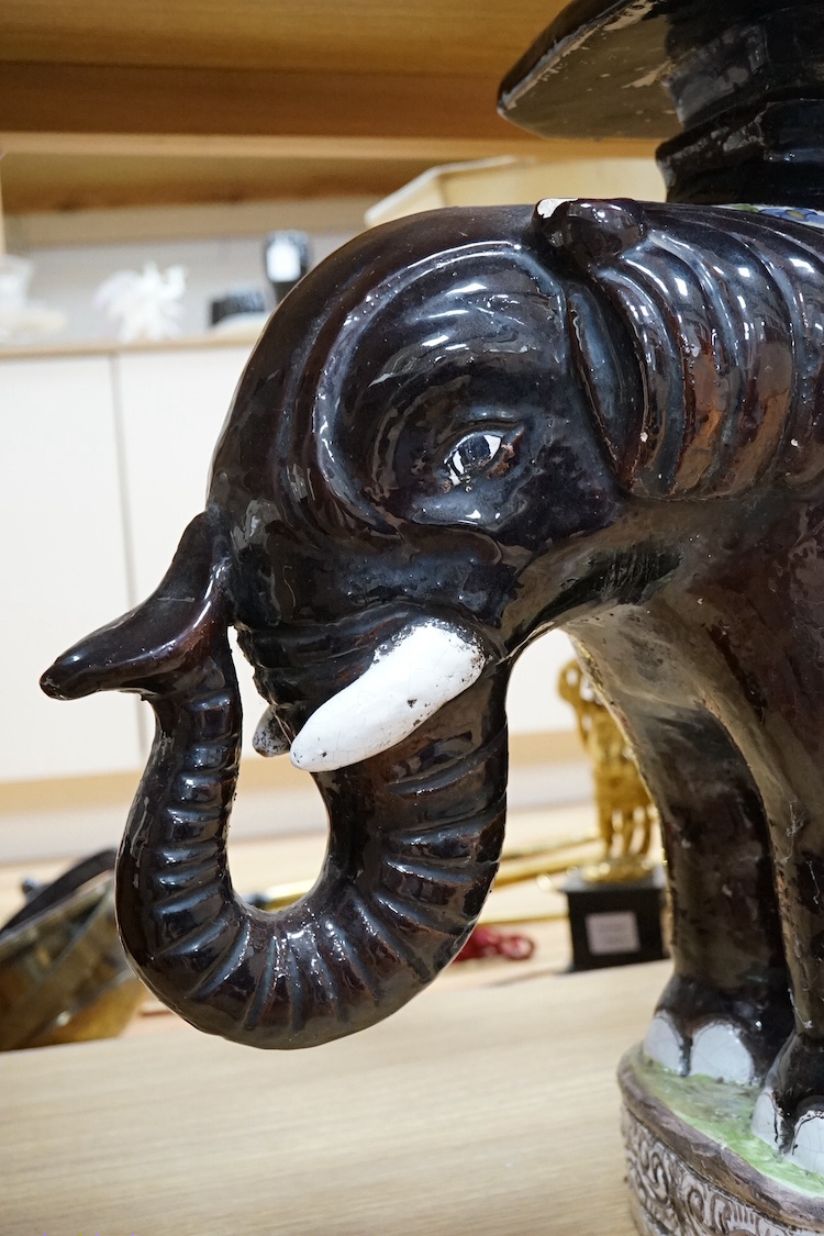 A modern Chinese style pottery conservatory seat in the form of an elephant, 64cm wide. Condition - fair